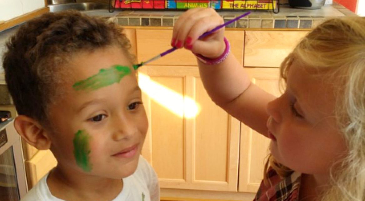 Two Little VIP kids carefully painting each other's faces